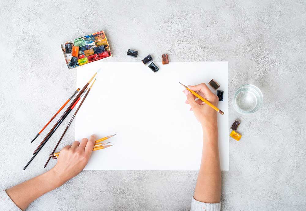 artist sketching on a blank page