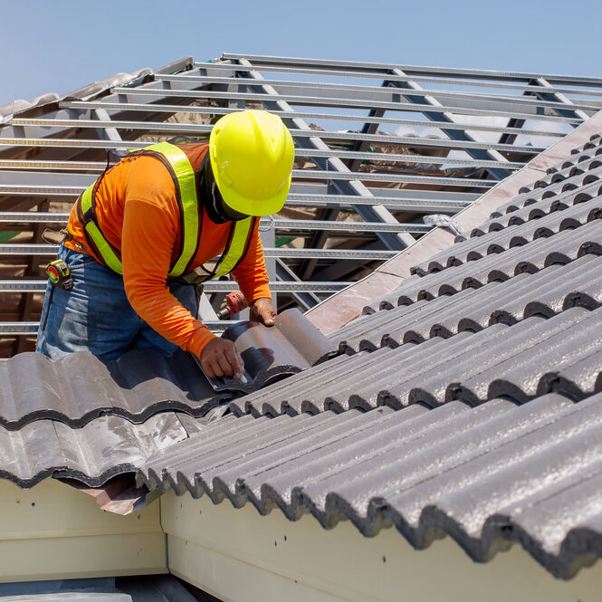 Construction,Roofer,Installing,Roof,Tiles,At,House,Building,Site