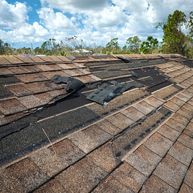 Damaged,House,Roof,With,Missing,Shingles,After,Hurricane,Ian,In