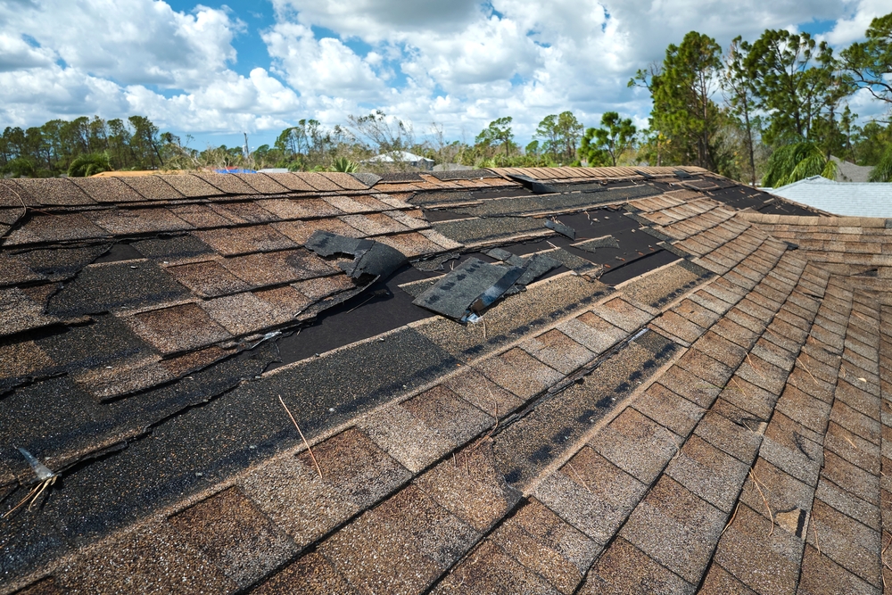 Damaged,House,Roof,With,Missing,Shingles,After,Hurricane,Ian,In