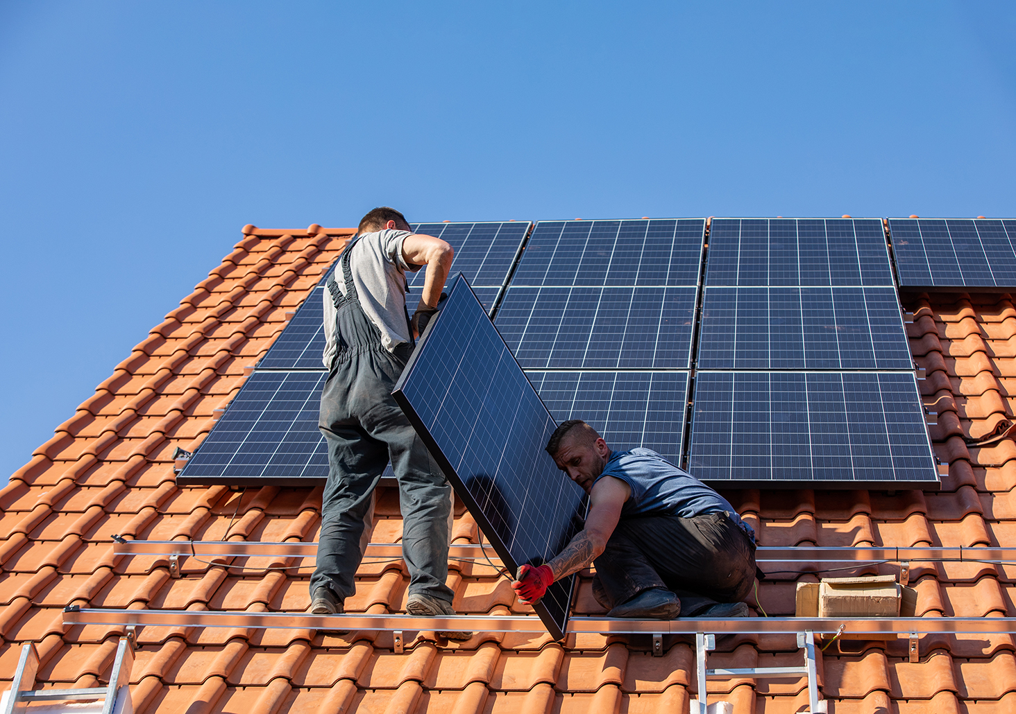 two man installing solar on the roof