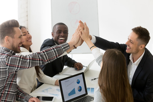Excited diverse millennial group giving high five celebrating online business win or shared goal achievement, colleagues congratulating with good result, performing team building. Rewarding concept