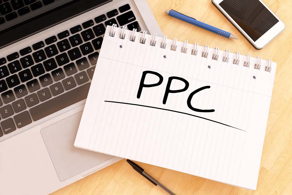 PPC - Pay per Click - handwritten text in a notebook on a desk - 3d render illustration.
