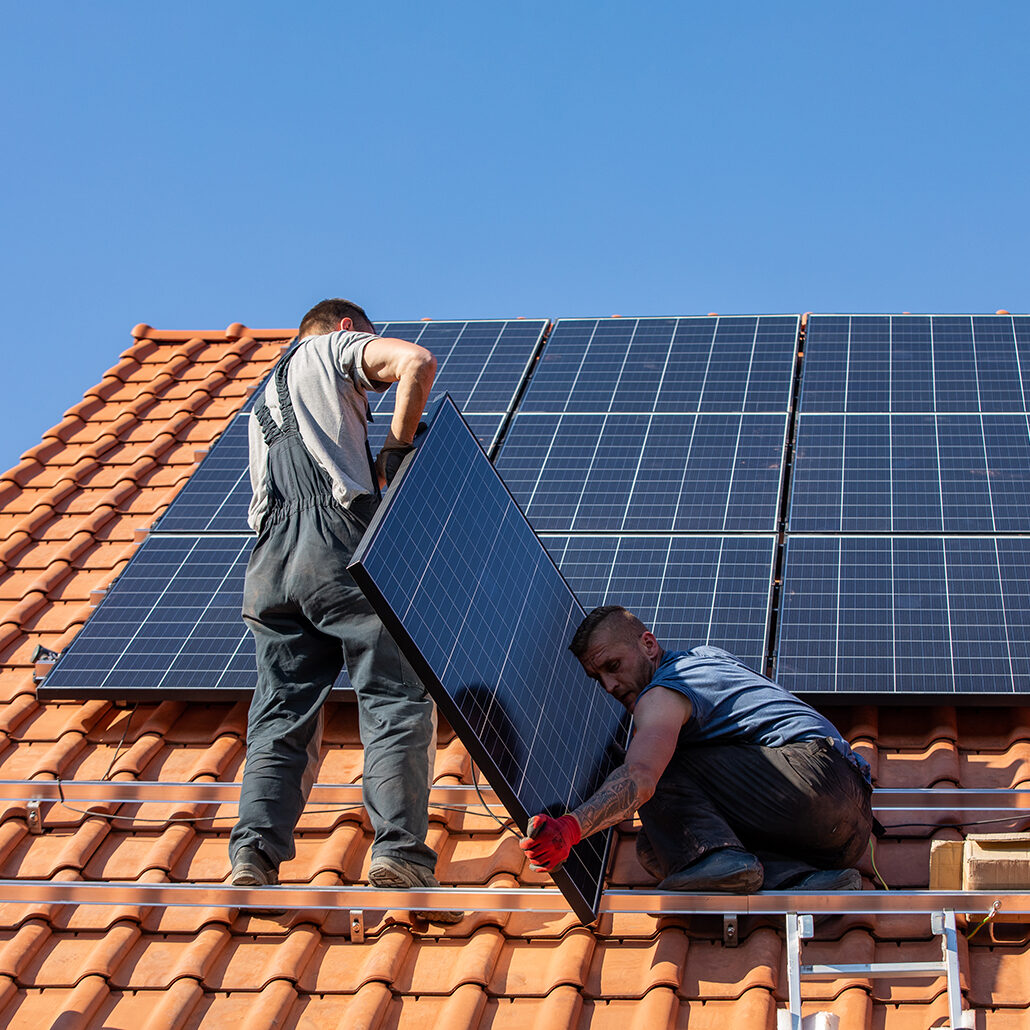 two man installing solar on the roof